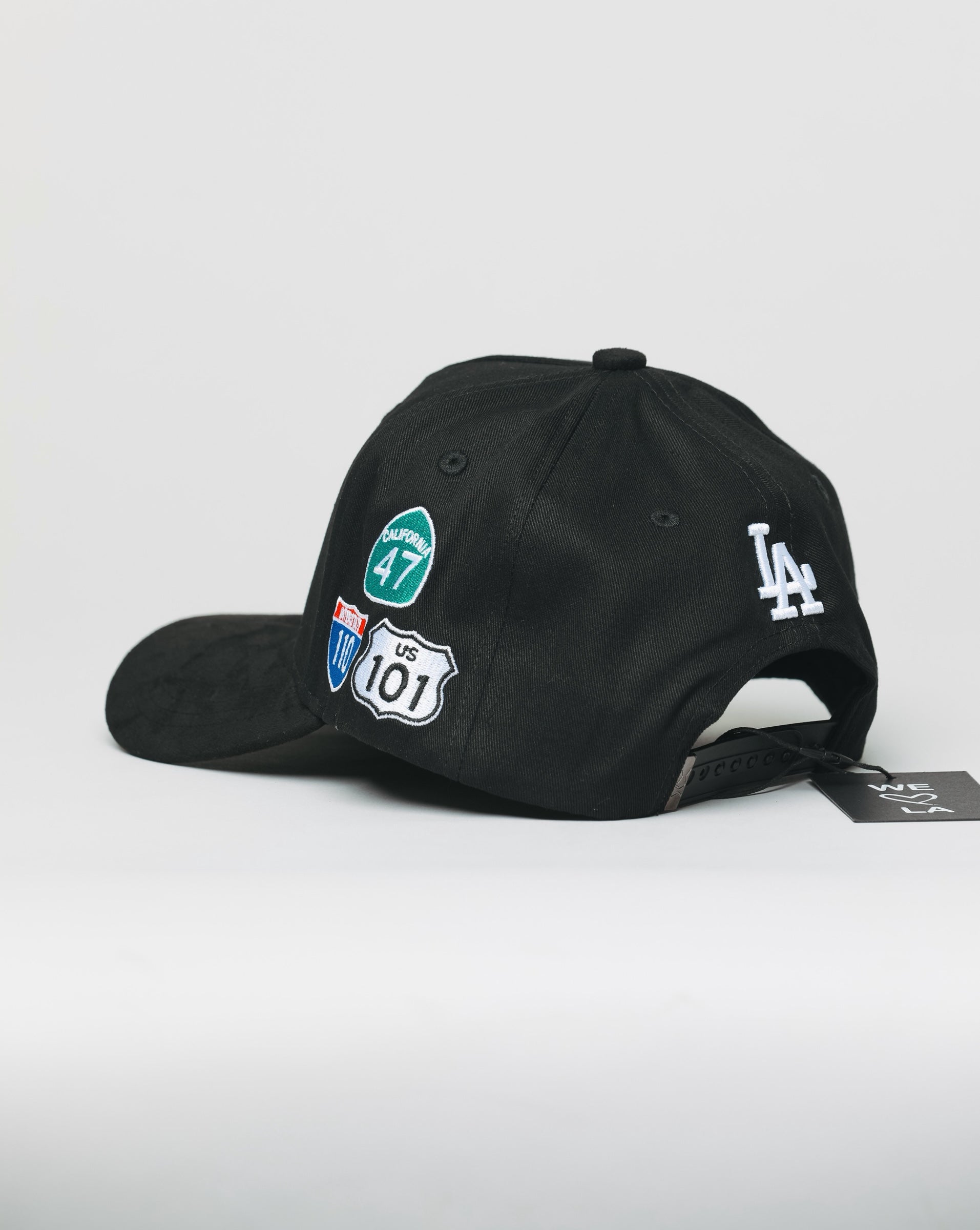 Black cap with various logos on a white background